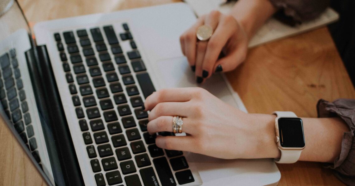 Woman`s hands on the laptop